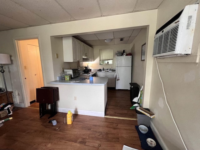 417 Forest Ave Unit 2, Morgantown, WV 26505 - kitchen featuring white appliances, a paneled ceiling, a peninsula, dark wood finished floors, and a wall mounted air conditioner