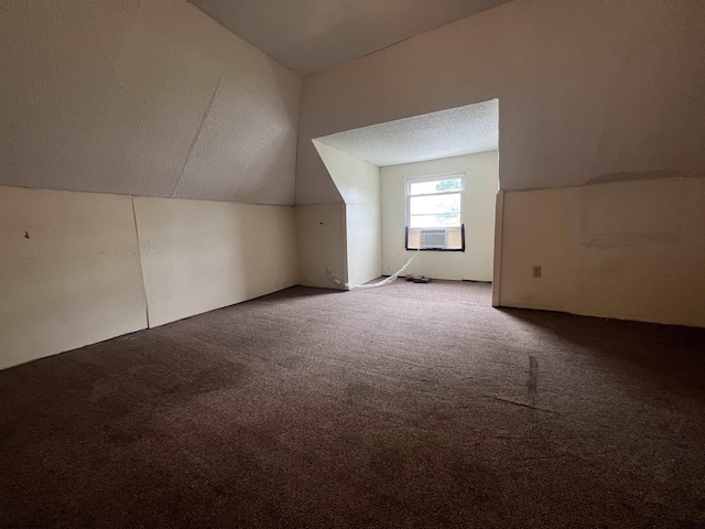 additional living space featuring vaulted ceiling, carpet flooring, and cooling unit