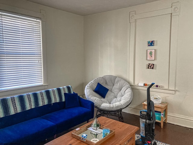 living area featuring baseboards