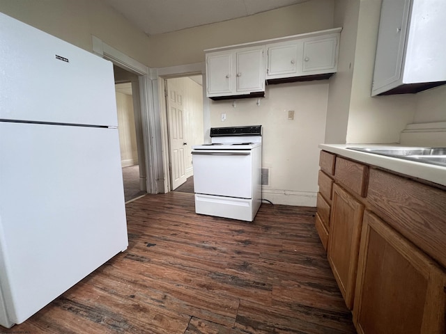 kitchen featuring white appliances, dark wood-style flooring, and light countertops