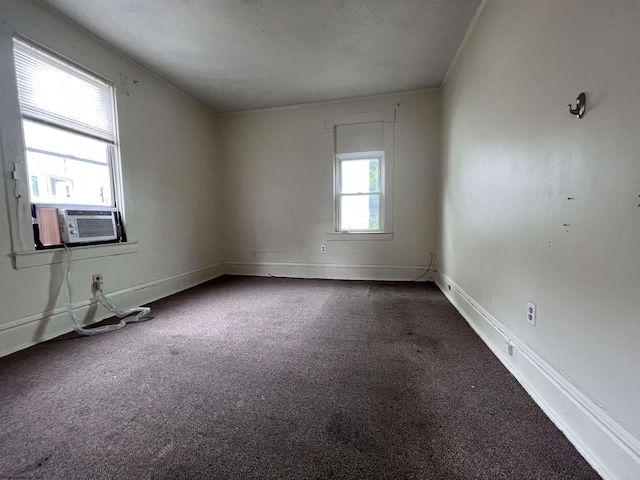 unfurnished room featuring cooling unit, carpet flooring, and baseboards