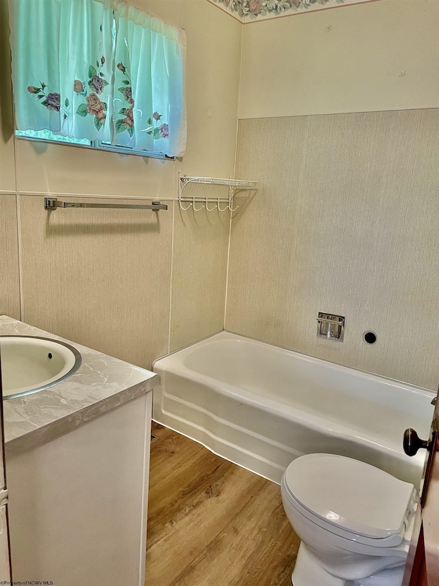 303 Morgantown St, Kingwood, WV 26537 - full bathroom featuring wood finished floors, a bath, vanity, and toilet