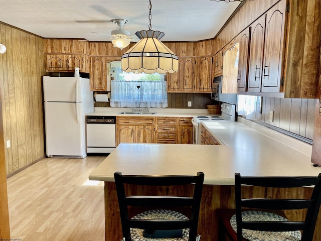 303 Morgantown St, Kingwood, WV 26537 - kitchen featuring white appliances, wood walls, a sink, light countertops, and ceiling fan