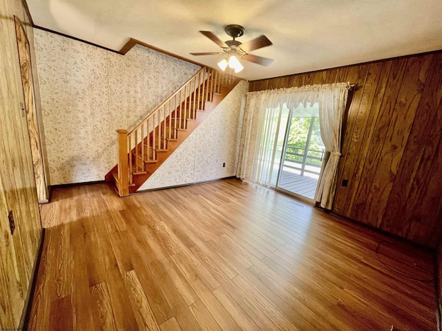 303 Morgantown St, Kingwood, WV 26537 - unfurnished living room featuring wallpapered walls, ceiling fan, stairs, wood finished floors, and crown molding