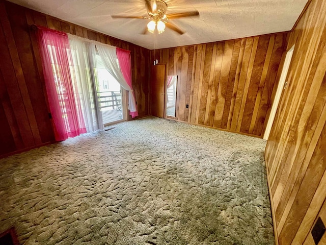 303 Morgantown St, Kingwood, WV 26537 - spare room with carpet, ceiling fan, and wooden walls