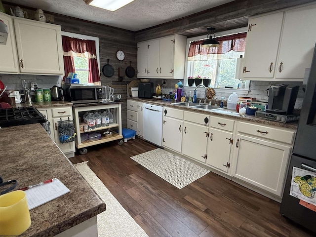4253 Point Mountain Rd, Monterville, WV 26282 - kitchen with white dishwasher, stainless steel microwave, a sink, a textured ceiling, and backsplash