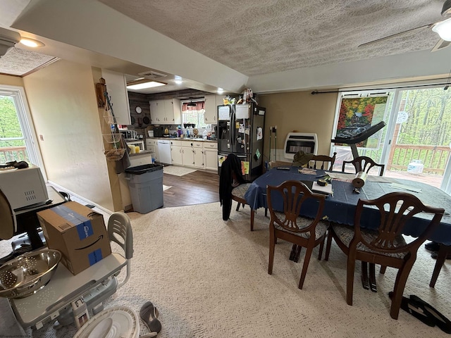 4253 Point Mountain Rd, Monterville, WV 26282 - dining room featuring heating unit, plenty of natural light, a textured ceiling, and wood finished floors