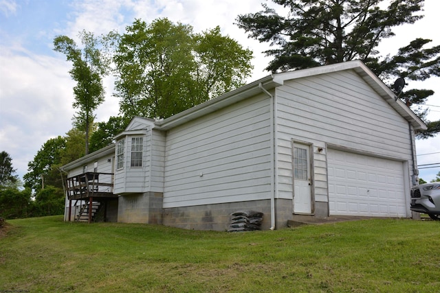 view of property exterior with a detached garage, a yard, and stairs