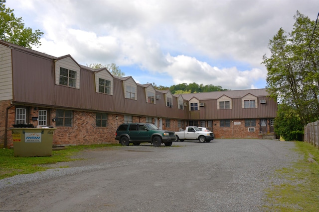 356 E 7th St Unit 10, Weston, WV 26452 - exterior space featuring a gambrel roof, brick siding, and uncovered parking