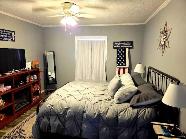 bedroom with ornamental molding, a textured ceiling, wood finished floors, and a ceiling fan