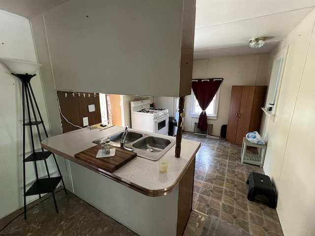 302 Jameson Ave, Parsons, WV 26287 - kitchen featuring a sink, white gas range oven, and a kitchen breakfast bar