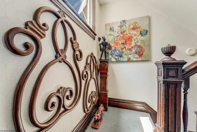 stairway featuring carpet