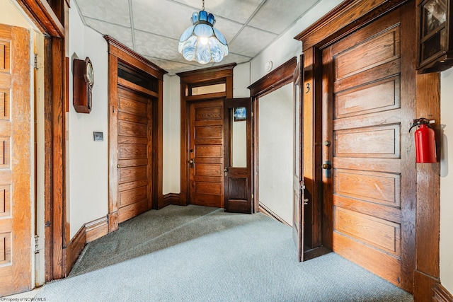 corridor featuring carpet floors and baseboards