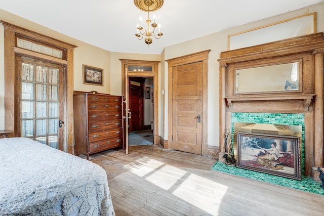 bedroom featuring light wood-style flooring and a chandelier