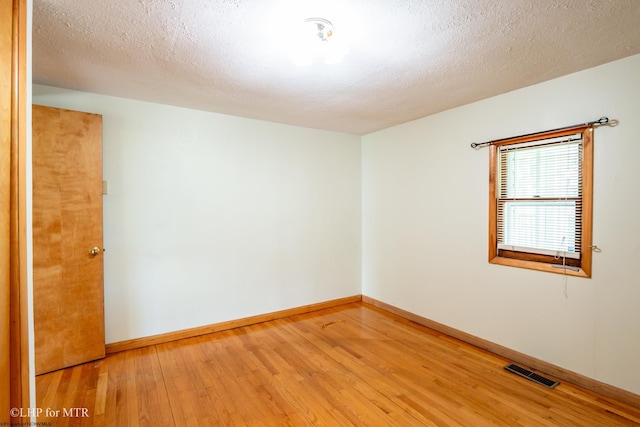 22 N Euclid Ave, Thomas, WV 26292 - unfurnished room with light wood-style floors, baseboards, and a textured ceiling
