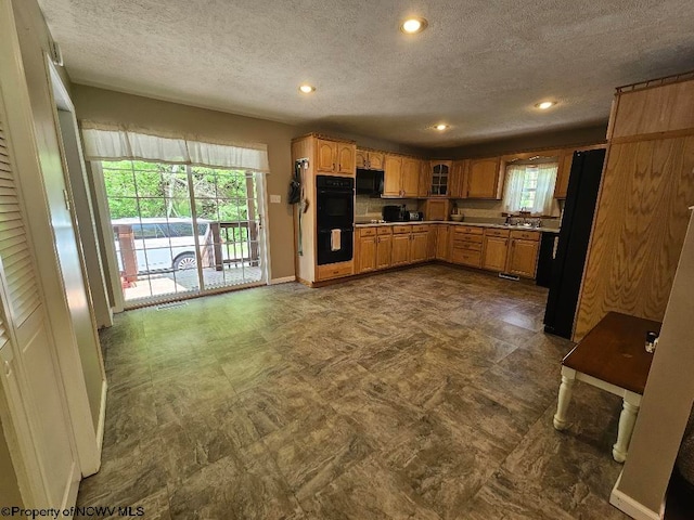760 Skelton Run, Wallace, WV 26448 - kitchen with a textured ceiling, black appliances, recessed lighting, glass insert cabinets, and baseboards