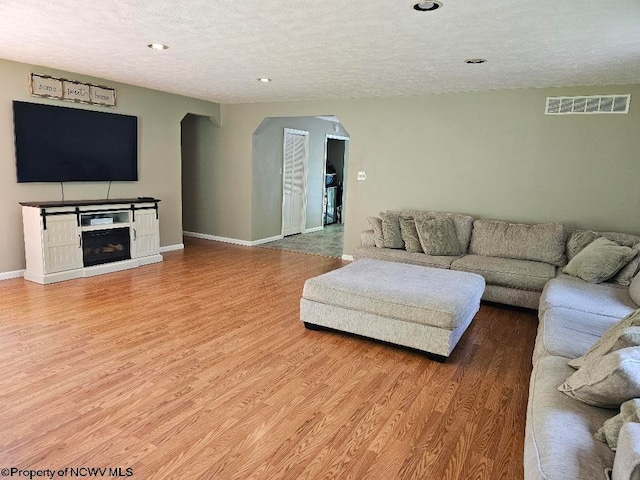 760 Skelton Run, Wallace, WV 26448 - living area featuring arched walkways, a textured ceiling, wood finished floors, recessed lighting, and baseboards