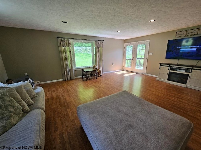 760 Skelton Run, Wallace, WV 26448 - living room with a textured ceiling, wood finished floors, french doors, baseboards, and a glass covered fireplace