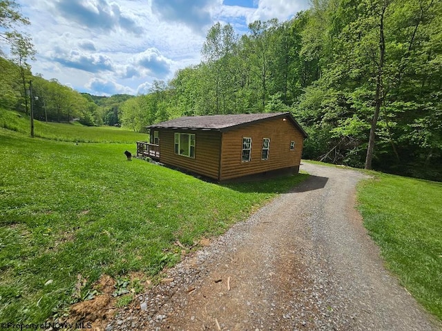 760 Skelton Run, Wallace, WV 26448 - view of side of property with a wooded view, driveway, a lawn, and log veneer siding