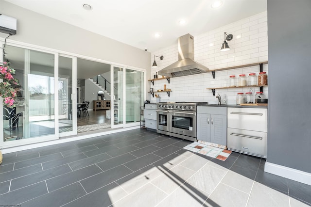 kitchen featuring exhaust hood, appliances with stainless steel finishes, open shelves, tasteful backsplash, and dark countertops