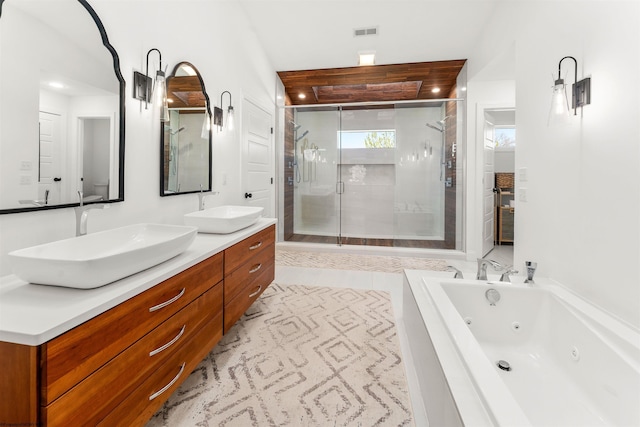 bathroom with a whirlpool tub, a shower stall, double vanity, and recessed lighting
