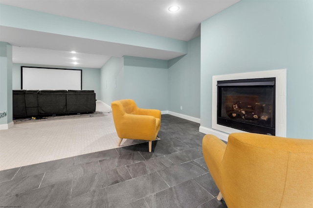 sitting room featuring a glass covered fireplace, baseboards, and recessed lighting