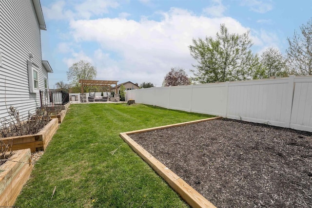view of yard with a vegetable garden and a pergola