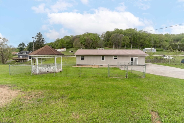 back of house with a gazebo and metal roof