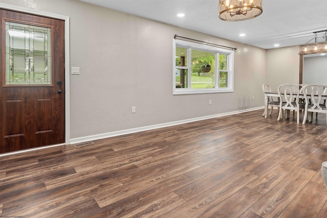 dining area with a chandelier, wood finished floors, baseboards, and recessed lighting