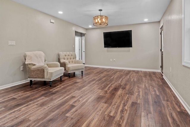 sitting room with wood finished floors, a chandelier, recessed lighting, and baseboards