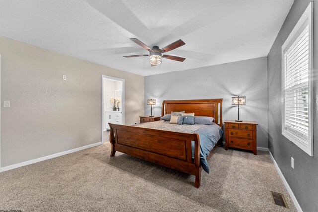carpeted bedroom featuring multiple windows, baseboards, and a ceiling fan