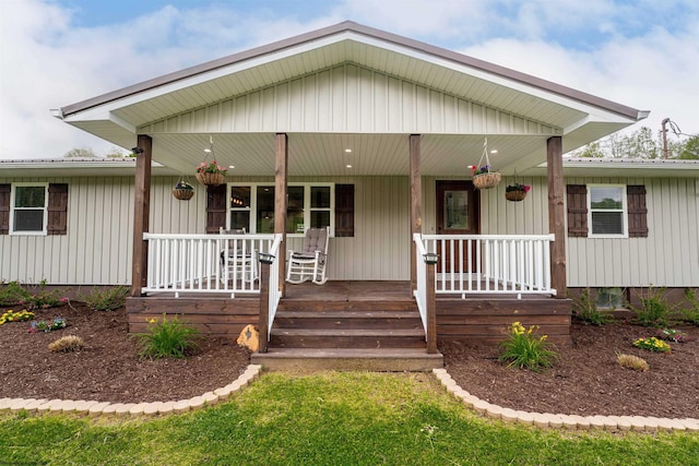 view of front of property with a porch and metal roof