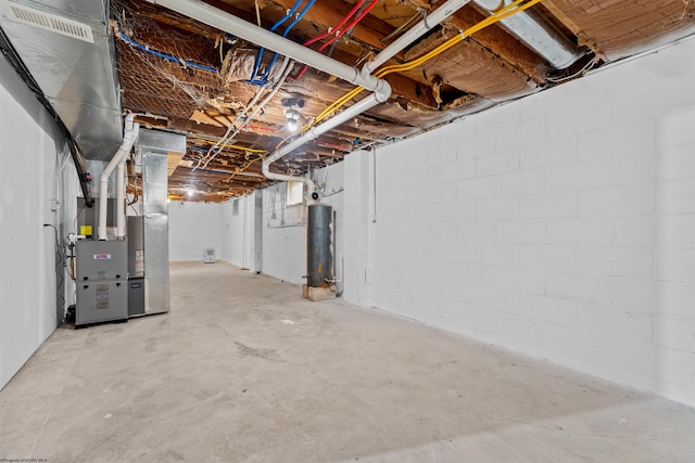 unfinished basement with water heater and heating unit