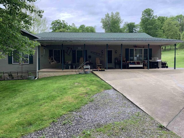 382 Knoll View Rd, Mount Clare, WV 26408 - rear view of property featuring a lawn, roof with shingles, concrete driveway, and a porch