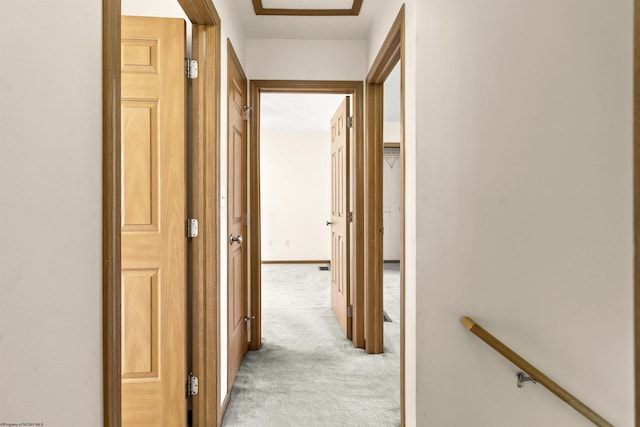 hallway featuring light carpet and an upstairs landing