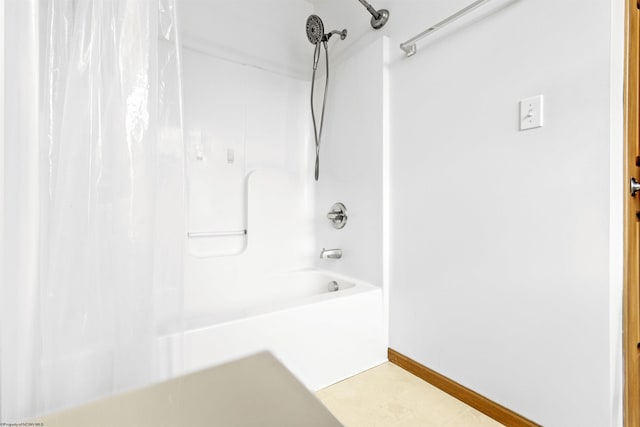 full bathroom featuring shower / bath combo with shower curtain and baseboards