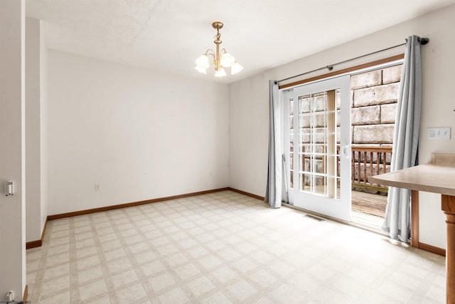 empty room with a chandelier, baseboards, light floors, and healthy amount of natural light