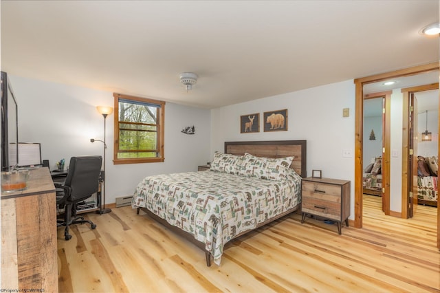 247 Daylily Ct, Terra Alta, WV 26764 - bedroom featuring light wood-style floors, an office area, baseboard heating, and baseboards