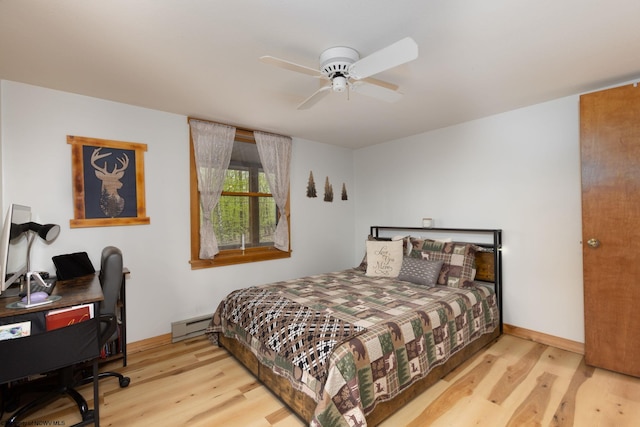 247 Daylily Ct, Terra Alta, WV 26764 - bedroom featuring a baseboard heating unit, wood finished floors, a desk, and a ceiling fan