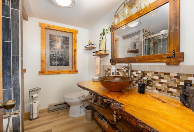 247 Daylily Ct, Terra Alta, WV 26764 - full bathroom with a baseboard radiator, wood finished floors, toilet, decorative backsplash, and a shower stall