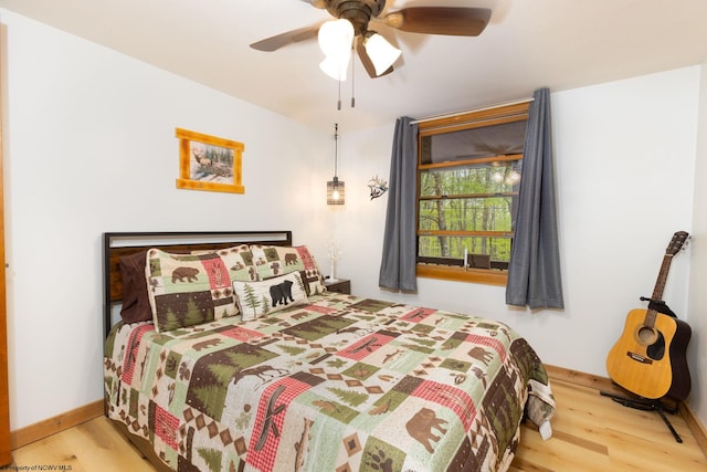247 Daylily Ct, Terra Alta, WV 26764 - bedroom with wood finished floors, a ceiling fan, and baseboards