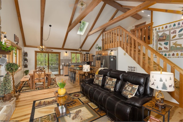 247 Daylily Ct, Terra Alta, WV 26764 - living area with light wood-style floors, high vaulted ceiling, a skylight, beamed ceiling, and stairway