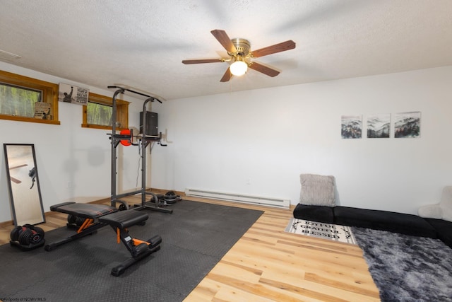 247 Daylily Ct, Terra Alta, WV 26764 - exercise room with a baseboard radiator, wood finished floors, ceiling fan, and a textured ceiling