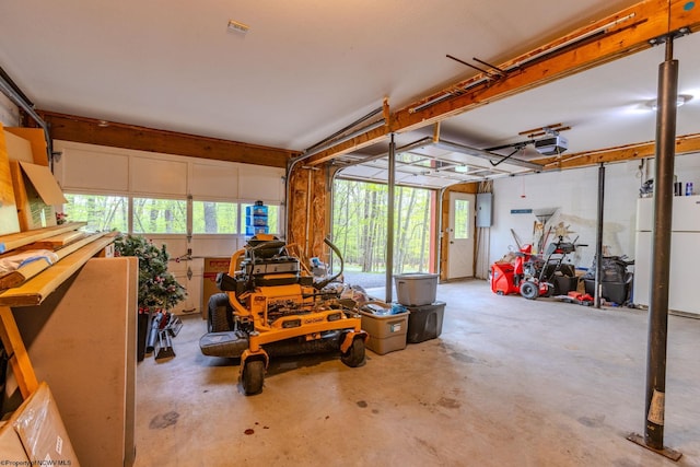 247 Daylily Ct, Terra Alta, WV 26764 - garage with a garage door opener, electric panel, and freestanding refrigerator