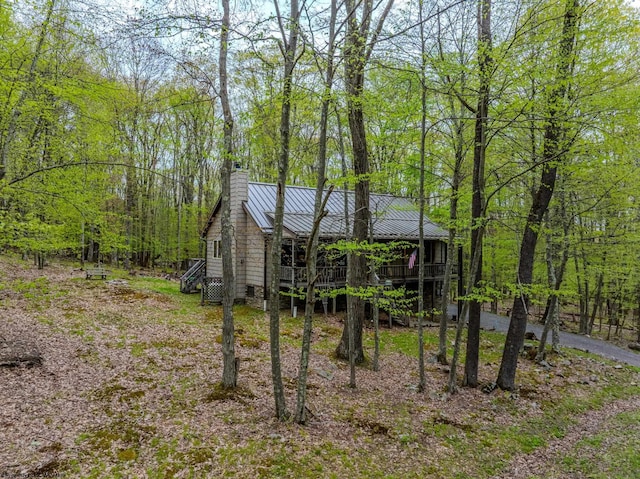247 Daylily Ct, Terra Alta, WV 26764 - view of side of property with a chimney, metal roof, a forest view, a standing seam roof, and a deck