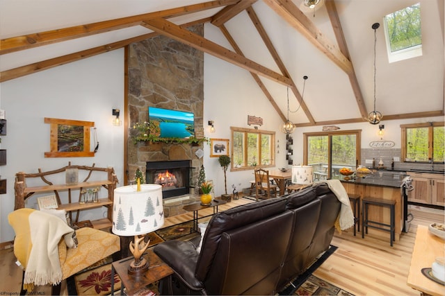 247 Daylily Ct, Terra Alta, WV 26764 - living area featuring light wood-style floors, high vaulted ceiling, beam ceiling, and a stone fireplace