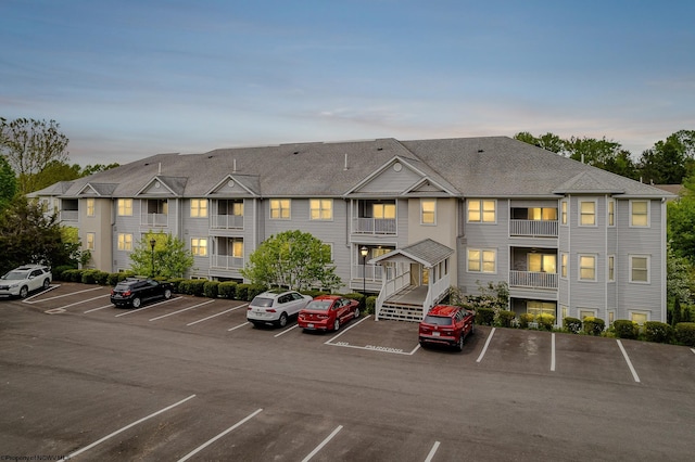 property at dusk featuring uncovered parking
