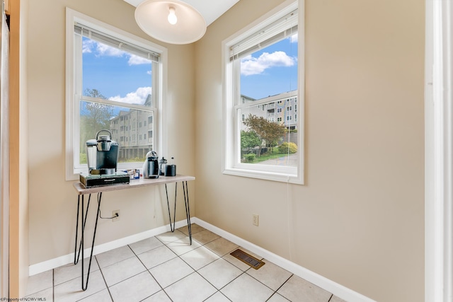 office featuring baseboards, healthy amount of natural light, and light tile patterned floors
