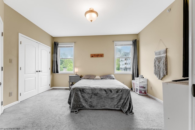 bedroom with multiple windows, carpet floors, and baseboards