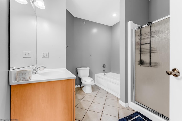 bathroom featuring tile patterned floors, a stall shower, toilet, and baseboards